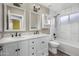 Stylish bathroom featuring dual sinks, a tub, and white marble-style tile surround at 15235 S 30Th St, Phoenix, AZ 85048