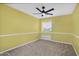 Bright bedroom with a ceiling fan and carpeted floors at 15235 S 30Th St, Phoenix, AZ 85048