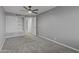 Cozy bedroom with neutral gray walls, carpet, ceiling fan, and a large closet for ample storage space at 15235 S 30Th St, Phoenix, AZ 85048