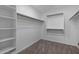 Bright, walk-in closet featuring carpeted floors and custom built-in shelving for optimal storage and organization at 15235 S 30Th St, Phoenix, AZ 85048
