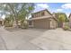 Classic two-story home featuring a two-car garage, neat landscaping, and a paved driveway at 15235 S 30Th St, Phoenix, AZ 85048