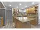 Modern kitchen features custom cabinets, granite countertops, stainless steel appliances, and a center island at 15235 S 30Th St, Phoenix, AZ 85048