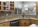 Kitchen featuring updated countertops and stainless steel dishwasher under the sink near a view to the backyard at 15235 S 30Th St, Phoenix, AZ 85048