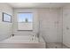 Well-lit bathroom with modern fixtures, a soaking tub, and a frameless shower at 1555 E Ocotillo Rd # 16, Phoenix, AZ 85014