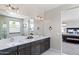 Bright bathroom featuring double sinks with elegant vanity and access to bedroom at 1555 E Ocotillo Rd # 16, Phoenix, AZ 85014
