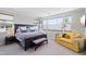 Beautiful bedroom with a stylish bed, sitting area, and lots of windows at 1555 E Ocotillo Rd # 16, Phoenix, AZ 85014