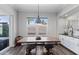 Inviting dining area with a wooden table and industrial chairs, with a serene outdoor view at 1555 E Ocotillo Rd # 16, Phoenix, AZ 85014