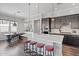 Well-lit kitchen boasts an expansive island, stylish stools, and top-of-the-line appliances at 1555 E Ocotillo Rd # 16, Phoenix, AZ 85014