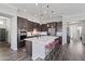 Modern kitchen with a large island, stainless steel appliances, dark cabinetry, and bar stool seating at 1555 E Ocotillo Rd # 16, Phoenix, AZ 85014