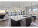 Bright kitchen featuring a large island with a marble countertop and modern pendant lighting at 1555 E Ocotillo Rd # 16, Phoenix, AZ 85014