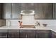 Close-up of the kitchen, showcasing custom cabinetry, subway tile backsplash, and stainless steel appliances at 1555 E Ocotillo Rd # 16, Phoenix, AZ 85014