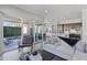 Bright open-concept living room with hardwood floors, a modern sofa, and access to the kitchen and patio at 1555 E Ocotillo Rd # 16, Phoenix, AZ 85014