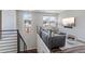 Upstairs living area with modern railing, lots of light, and an inviting seating arrangement at 1555 E Ocotillo Rd # 16, Phoenix, AZ 85014