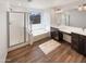 Bright bathroom showcasing dual sinks, a soaking tub, and a glass enclosed shower at 16236 W La Ventilla Way, Goodyear, AZ 85338