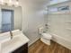 Well-lit bathroom features a single sink vanity and shower-tub combo at 16236 W La Ventilla Way, Goodyear, AZ 85338