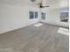 Large, carpeted bedroom with ceiling fan and multiple windows providing natural light at 16236 W La Ventilla Way, Goodyear, AZ 85338