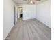 A carpeted bedroom is shown with a ceiling fan and a door to the bathroom at 16236 W La Ventilla Way, Goodyear, AZ 85338
