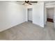 Neutral bedroom with light-colored carpet, a ceiling fan, and a closet with sliding doors at 16236 W La Ventilla Way, Goodyear, AZ 85338