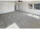 Spacious, carpeted bedroom with ceiling fan and two windows for natural light at 16236 W La Ventilla Way, Goodyear, AZ 85338