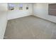 Spacious bedroom with light colored carpet, three large windows, and white walls at 16236 W La Ventilla Way, Goodyear, AZ 85338