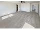 Open, carpeted bedroom space with a ceiling fan and multiple windows at 16236 W La Ventilla Way, Goodyear, AZ 85338
