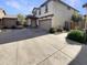Beautiful home exterior with a two-car garage and well-maintained driveway at 16236 W La Ventilla Way, Goodyear, AZ 85338