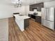 Modern kitchen features stainless steel appliances and a large center island at 16236 W La Ventilla Way, Goodyear, AZ 85338