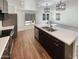 Modern kitchen with stainless steel appliances, a large island, and dark cabinets at 16236 W La Ventilla Way, Goodyear, AZ 85338