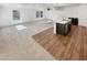 Open-concept living room and kitchen, featuring carpet, wood flooring, and stainless appliances at 16236 W La Ventilla Way, Goodyear, AZ 85338