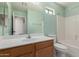 Bathroom showcasing vanity, toilet, and shower-tub combo with neutral color scheme at 1642 E Desert Ln, Phoenix, AZ 85042