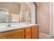 Bathroom features a double vanity, large mirror, and natural wood cabinets at 1642 E Desert Ln, Phoenix, AZ 85042