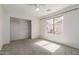 Bright bedroom with a ceiling fan, window, and closet at 1642 E Desert Ln, Phoenix, AZ 85042