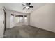 Large bedroom featuring a ceiling fan, bay window, and neutral carpeting at 1642 E Desert Ln, Phoenix, AZ 85042