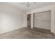Bedroom featuring carpet, closet, door to hallway and access to another room at 1642 E Desert Ln, Phoenix, AZ 85042