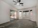 Large main bedroom with backyard views from three separate windows and sliding glass doors at 1642 E Desert Ln, Phoenix, AZ 85042