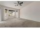 Large bedroom with carpet, a ceiling fan, and a bay window at 1642 E Desert Ln, Phoenix, AZ 85042
