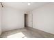 Carpeted bedroom with neutral walls and access to other areas of the home at 1642 E Desert Ln, Phoenix, AZ 85042
