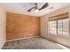 Spacious bedroom featuring a ceiling fan, plush carpet and a window with lots of light at 1642 E Desert Ln, Phoenix, AZ 85042