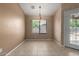 Cozy dining room with neutral tile floors, pendant lighting and backyard view through the window at 1642 E Desert Ln, Phoenix, AZ 85042
