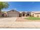 Charming single-story home with a two-car garage and low maintenance desert landscaping at 1642 E Desert Ln, Phoenix, AZ 85042
