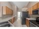Kitchen features laminate counters, tiled floors, wooden cabinets, and stainless steel appliances at 1642 E Desert Ln, Phoenix, AZ 85042