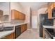 Efficient kitchen design with stainless steel appliances, wood cabinets, and tile flooring at 1642 E Desert Ln, Phoenix, AZ 85042