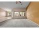 Open concept living area with carpet flooring and bright natural light from multiple windows at 1642 E Desert Ln, Phoenix, AZ 85042