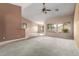 View of living area with carpet flooring, neutral walls and open concept design at 1642 E Desert Ln, Phoenix, AZ 85042