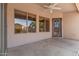 Covered patio area featuring outdoor access and exterior views through windows at 1642 E Desert Ln, Phoenix, AZ 85042