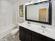 Well-lit bathroom featuring a double sink vanity, framed mirror, and a shower-tub combo at 19904 W Sherman St, Buckeye, AZ 85326