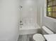 Bathroom showcasing a standard white tub with shower, toilet, and a window at 19904 W Sherman St, Buckeye, AZ 85326
