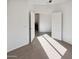 Bedroom with open doors, bright sunlight, and carpet flooring at 19904 W Sherman St, Buckeye, AZ 85326
