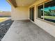 This covered patio has a sliding glass door to the home's interior and a large window for natural light at 19904 W Sherman St, Buckeye, AZ 85326