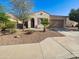 Inviting home exterior with a charming facade, desert landscaping, and a convenient two-car garage at 19904 W Sherman St, Buckeye, AZ 85326